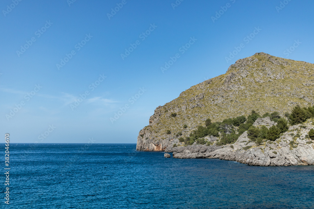 Sunny day over the rocks and the blue water in Sa Calobra, Palma de Mallorca, Balearic Islands, Spain