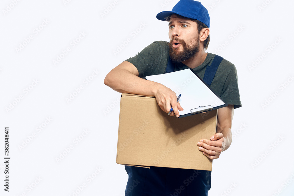 Man in working uniform box delivery loader courier light background Man in working uniform box delivery loader courier light background