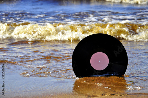 Vinyl record on the sand.