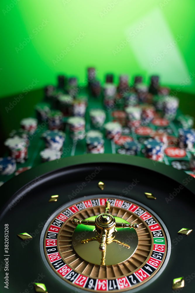 Casino theme, close up of roulette, red and black numbers. Stack of chips in the background.
Casino theme, close up of roulette, red and black numbers. Stack of chips in the background.