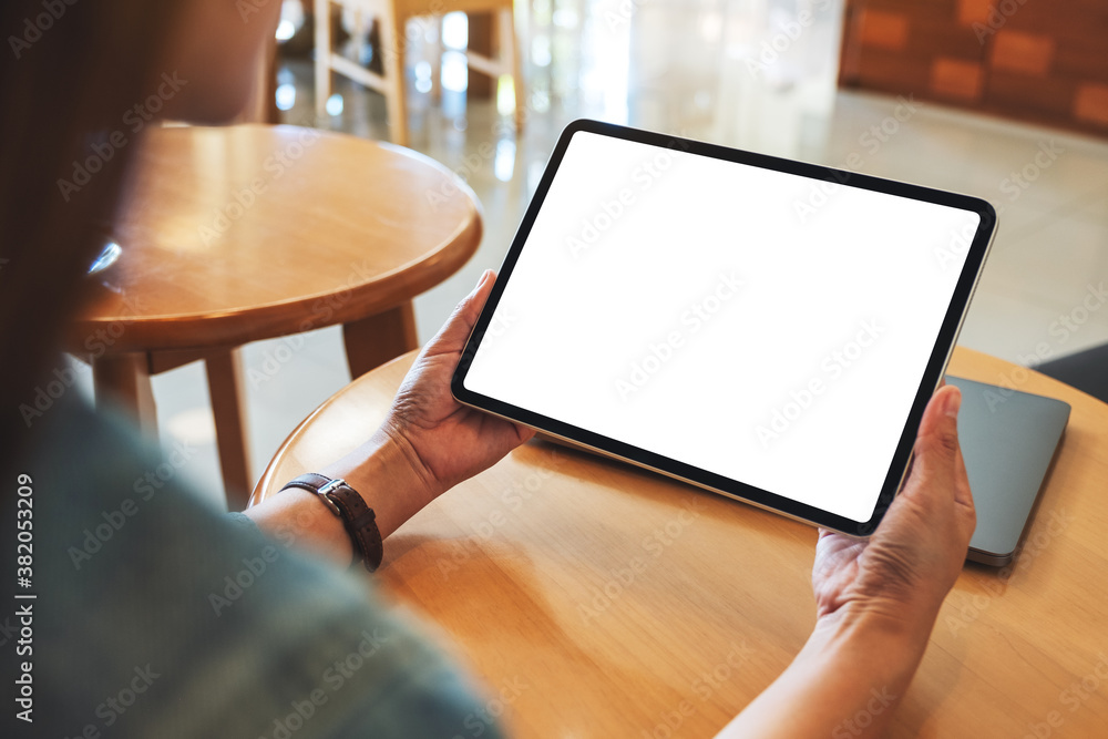 Fototapeta premium Mockup image of a woman holding digital tablet with blank white desktop screen