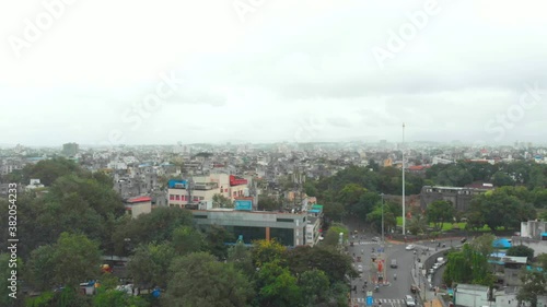 Dolly forward drone shot over Shaniwar wada traffic on Chhatrapati Shivaji bridge road Dr Hegdwar chowk old Pune city heritage site India photo