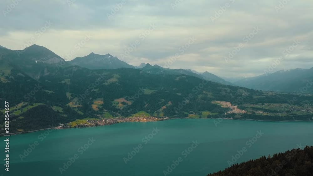 Green forest over Blue Lake in valley cloudy day Green forest over Blue Lake in valley cloudy day