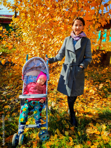 child playing in autumn park
