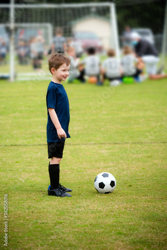 Happy young boy playing organized soccer