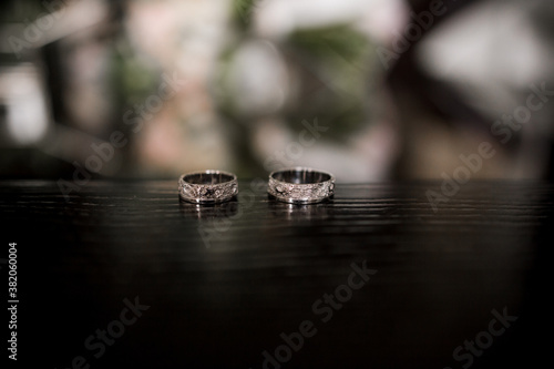 wedding rings lie on a dark table © dyachenkopro