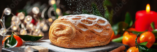 Apple strudel with tangerines and cinnamon sprinkled with sugar powder photo