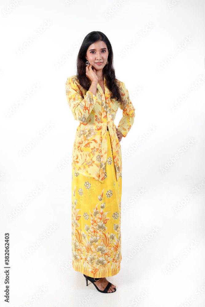 South east Asian Indian race ethnic origin woman wearing yellow kebaya baju kurung dress costume multiracial community on white background South east Asian Indian race ethnic origin woman wearing yellow kebaya baju kurung dress costume multiracial community on white background