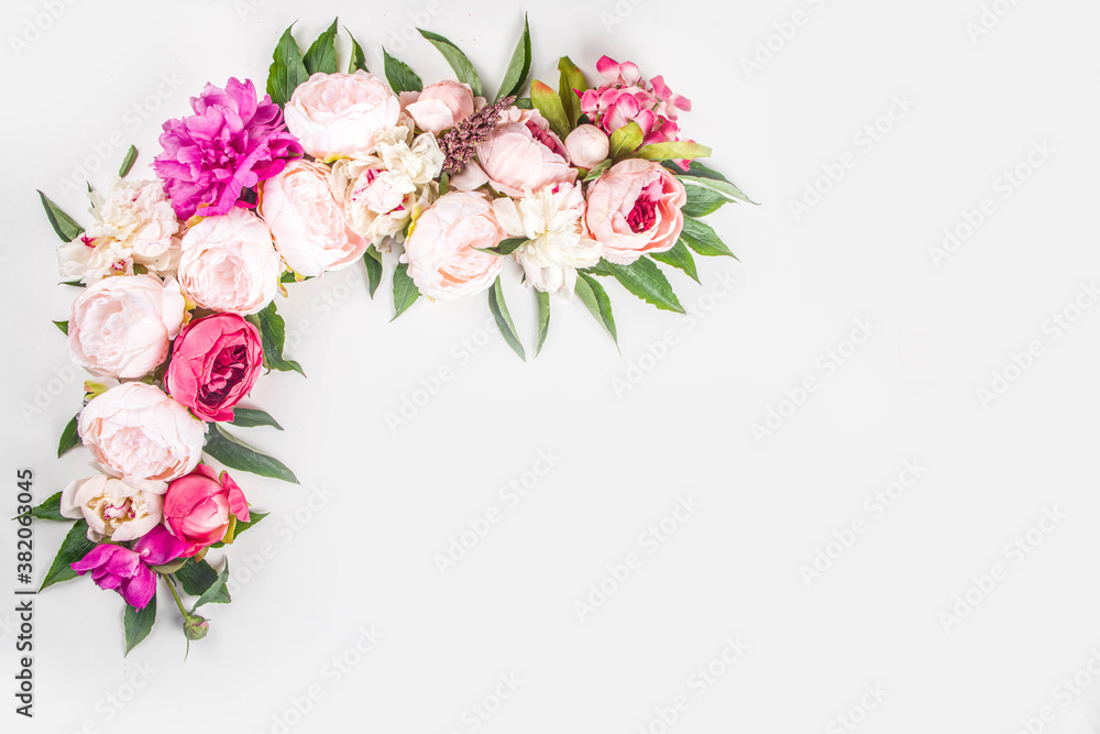 Flat lay of flowers and green leaves