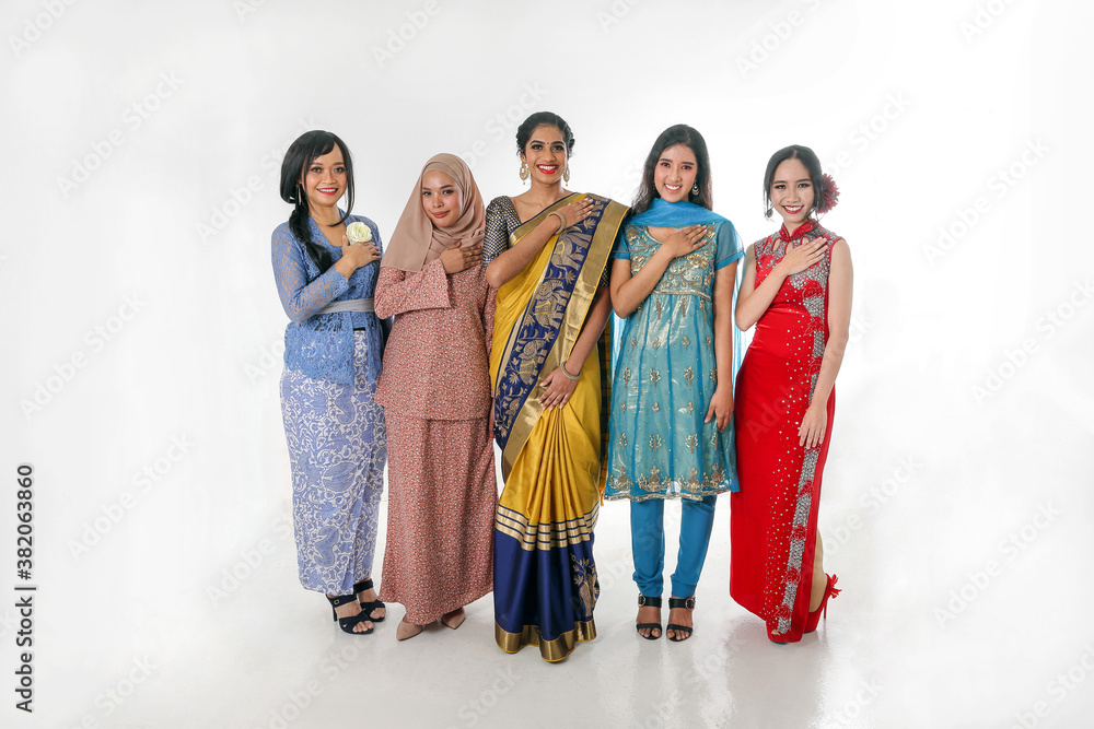 South east Asian Malay Chinese Indian race ethnic origin woman wearing dress costume baju kurung cheongsam samfu kebaya Sharee multiracial community on white background welcome hand on chest