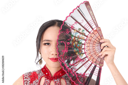South east Asian Chinese race ethnic origin woman wearing red velvet cheongsam with hand stitched sequence work dress costume hand fan on white background