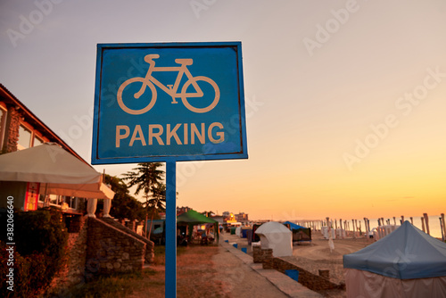 Bike parking sign on the sea beach. photo