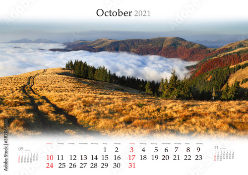 Calendar October 2021, B3 size. Set of calendars with amazing landscapes. Old country road in the fogge mountains. Impressive autumn view of Carpathian mountains, Ukraine, Europe.