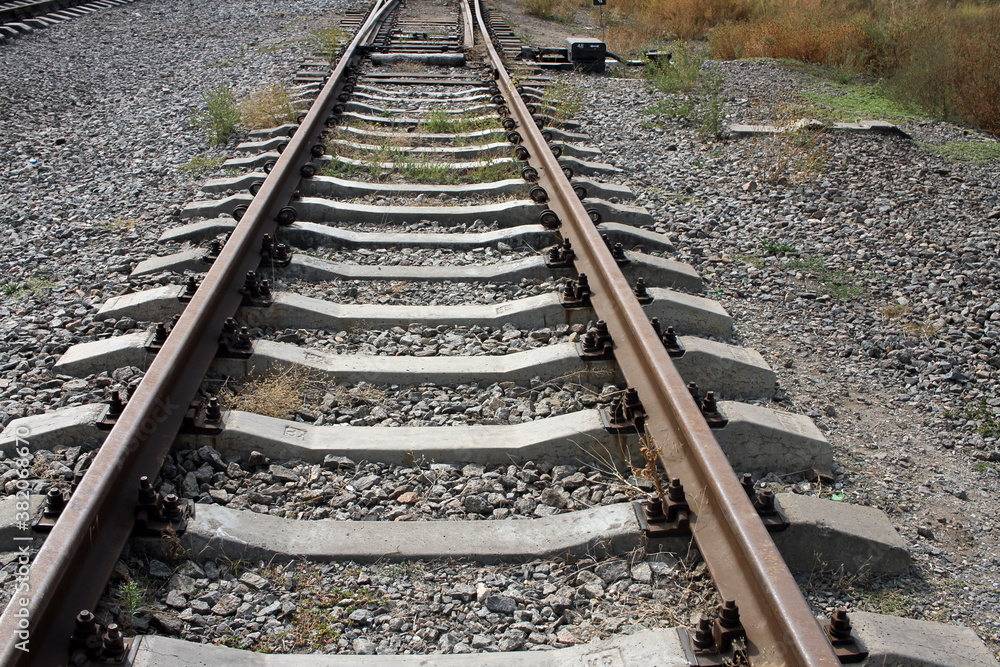 railroad, old rails and stones, photographed during the day, the outgoing perspective is visible