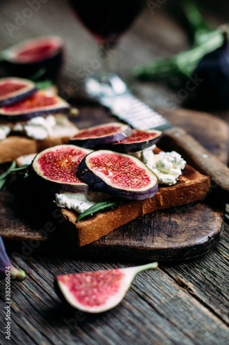 Toast with cream cheese, figs and honey on the table