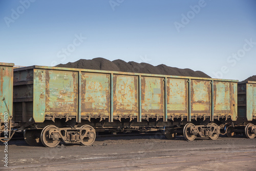 Freight wagons on the railways are filled with bulk cargo. Delivery and transshipment of coal.