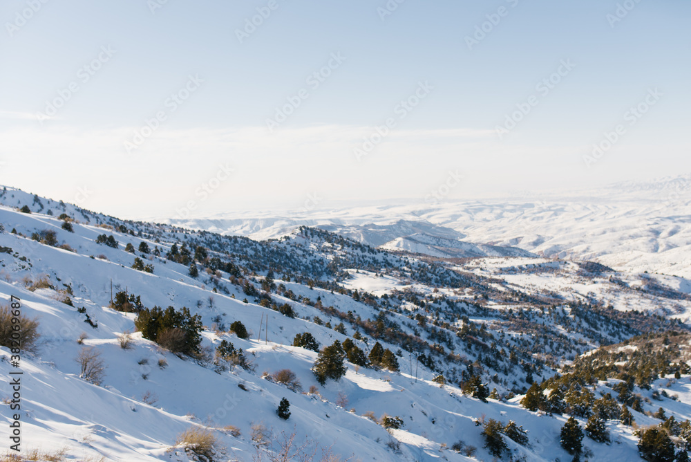 Panorama of the Tien Shan mountains, which opens from the top of a mountain pass in the resort of Beldersay in Uzbekistan