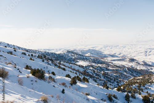 Panorama of the Tien Shan mountains, which opens from the top of a mountain pass in the resort of Beldersay in Uzbekistan photo