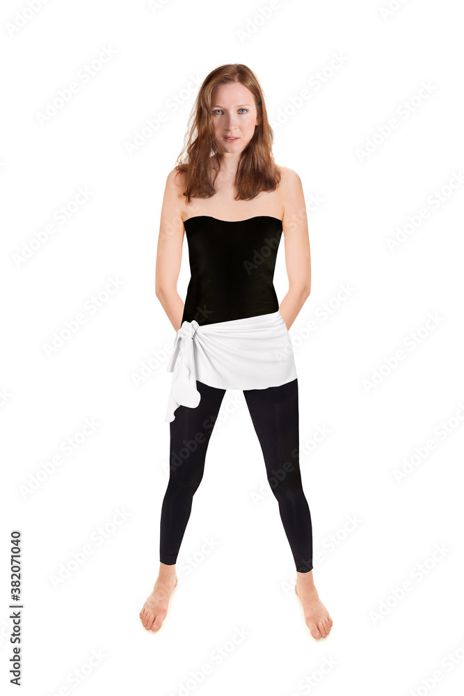 Fit brunette woman wearing black leggings and top, full length portrait isolated in front of white studio background Fit brunette woman wearing black leggings and top, full length portrait isolated in front of white studio background