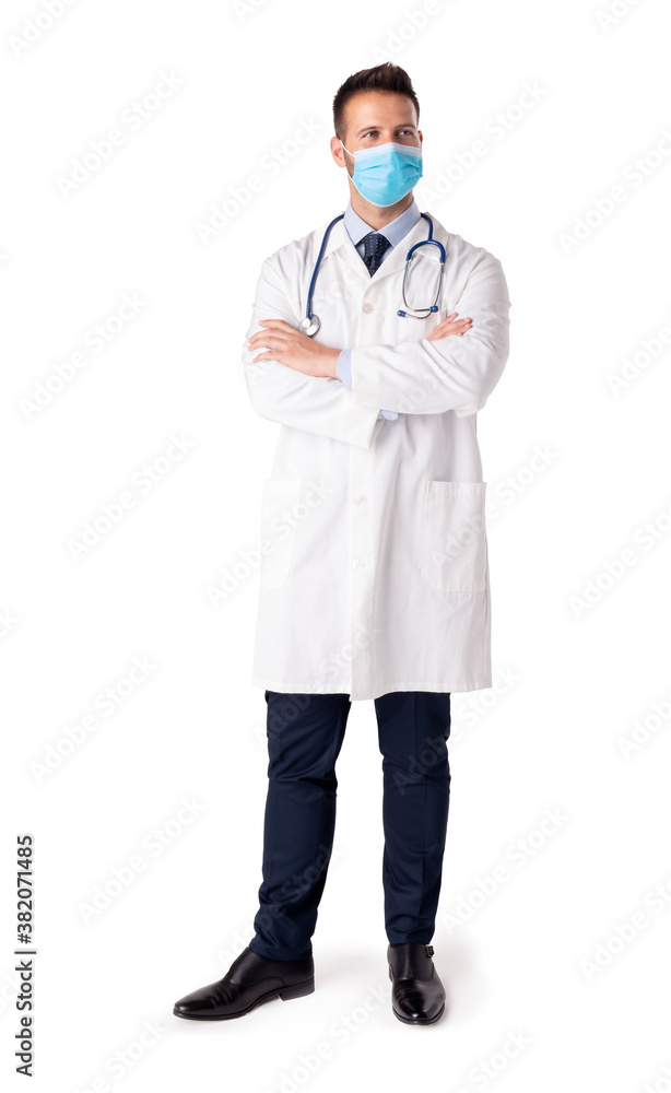 Portrait of male doctor while wearing face mask and standing at isolated background Portrait of male doctor while wearing face mask and standing at isolated background