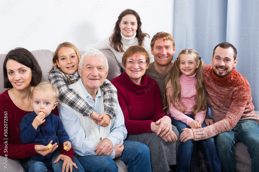 Fototapeta premium Smiling family making numerous photos during family dinner