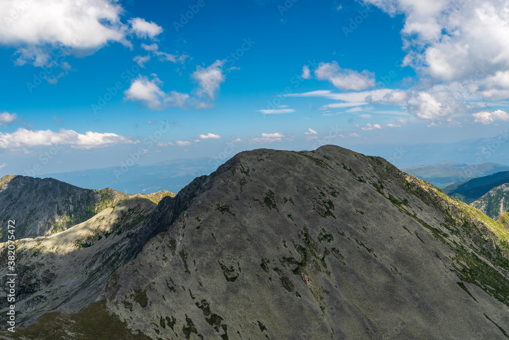 Varful Papusa with few other peaks from Varful Peleaga mountain peak in Retezat mountains in Romania