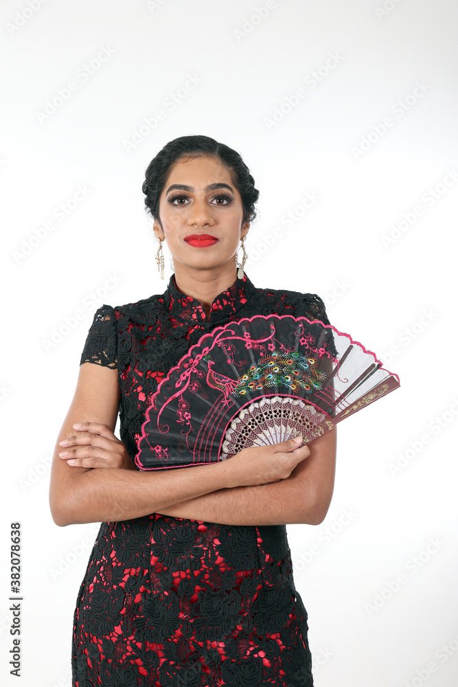 South east Asian Indian race ethnic origin woman wearing Chinese dress costume Cheongsam holding hand fan multiracial community on white background South east Asian Indian race ethnic origin woman wearing Chinese dress costume Cheongsam holding hand fan multiracial community on white background