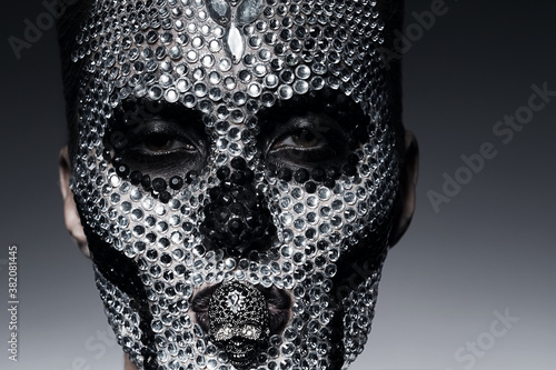 woman in rhinestones with skull face