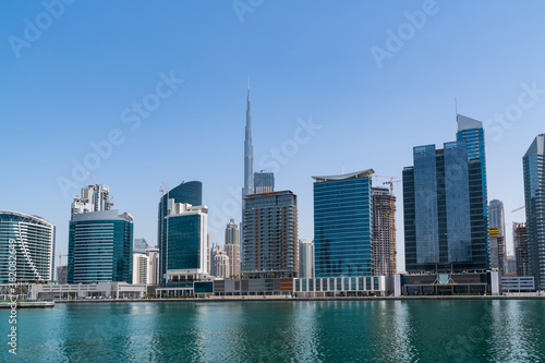 Panoramic view of skyscrapers of downtown of Dubai, UAE at Dubai Canal, Business Bay. Modern cityscape of the capital of the Emirate of Dubai. A center of new financial tech of Western Asia © VideoFlow