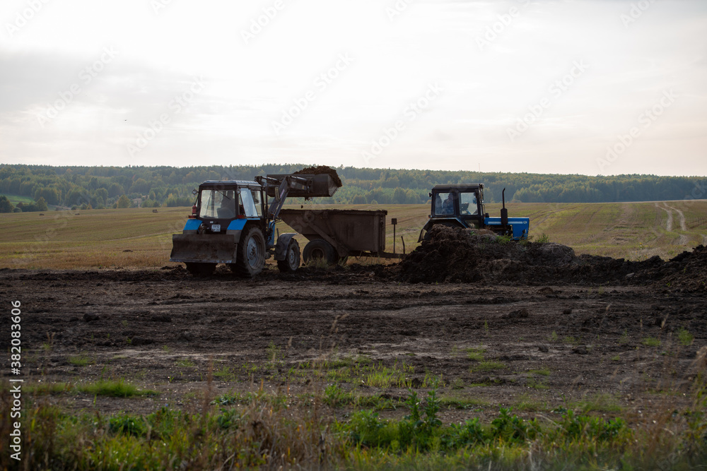 Fototapeta premium agricultural machines at work in the field