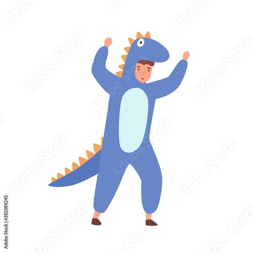 Funny boy in dinosaur costume raising hands make scaring gesture vector flat illustration. Cute male kid actor in carnival apparel isolated on white background. Childish masquerade or theme party