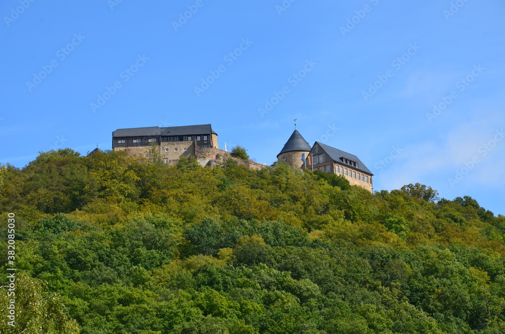 View of the fortress Waldeck on a mountain at the Edersee with blue sky in the background