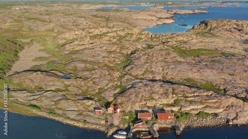 Granite rock formations on Swedish west coast bohuslan. Aerial drone shot of nature with flat stones and gravel. Few small fishing houses. Green vegetation and plenty of bare rocks and cliffs. Sweden photo