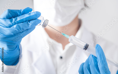 Caucasian doctor with syringe for vaccination.