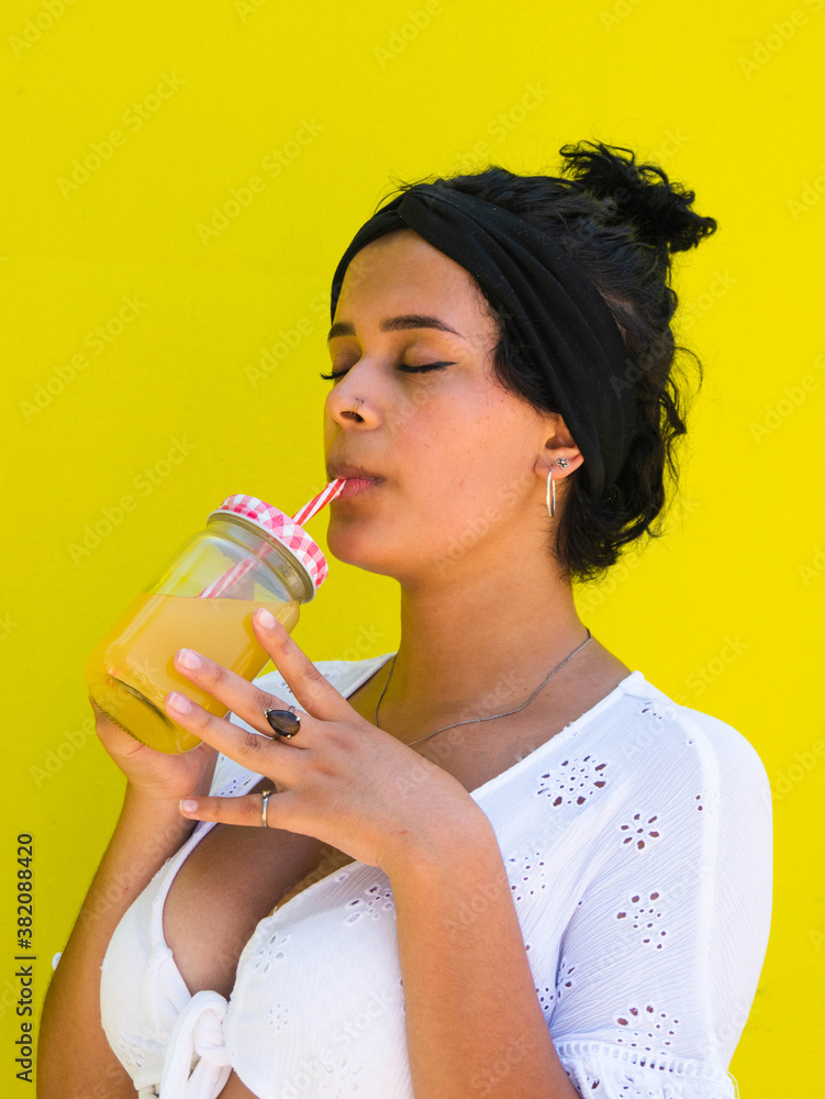 attractive Brazilian female with pineapple on yellow background. attractive Brazilian female with pineapple and juice on yellow background attractive Brazilian female with pineapple on yellow background. attractive Brazilian female with pineapple and juice on yellow background