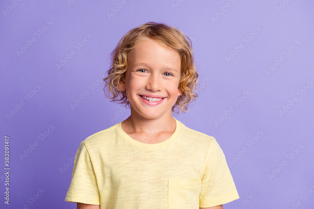 Portrait of pretty little kid look in camera toothy smiling wear casual style t-shirt isolated over violet color background Portrait of pretty little kid look in camera toothy smiling wear casual style t-shirt isolated over violet color background
