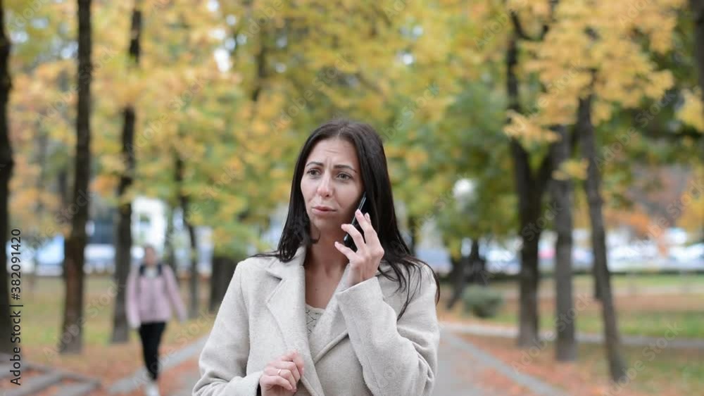 beautiful girl in autumn coat talking on the phone outdoor beautiful girl in autumn coat talking on the phone outdoor