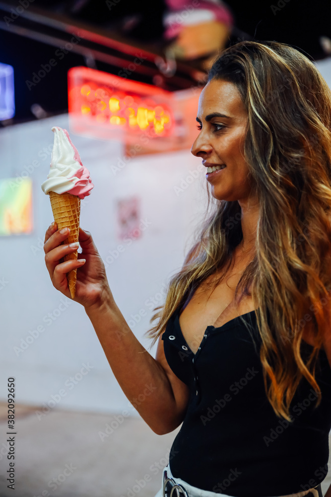 Vertical shot of an attractive caucasian female with ice-cream