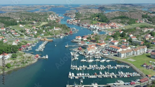 Sweden west coast village from above. Small coastal town with boats and harbour aerial drone shot. Swedish summer at the ocean. Archipelago island landscape view. Bohus Gothenburg. Houses small hotel photo