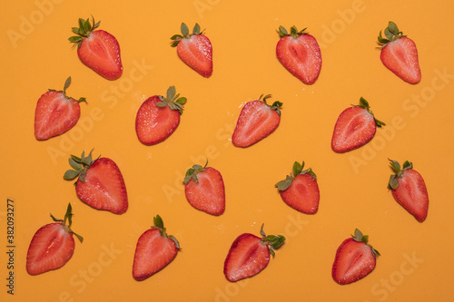 Fototapeta Naklejka Na Ścianę i Meble -  Top view of strawberry slices on an orange background