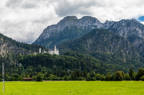 Beautiful view to the castle Neuschanstein in Füssen, Bavaria, Germany at a cloudy day in summer.