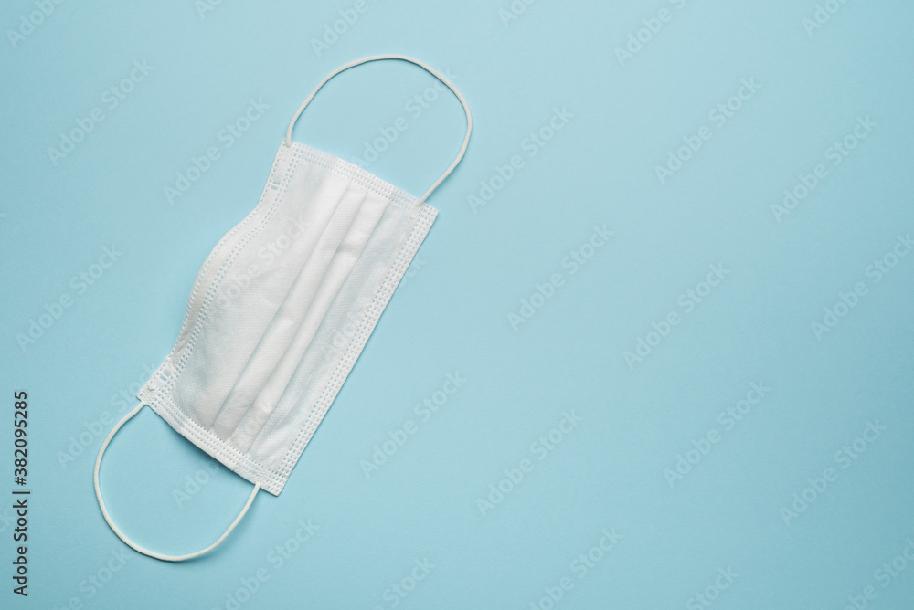 Obraz premium Surgical protective face mask white on blue background