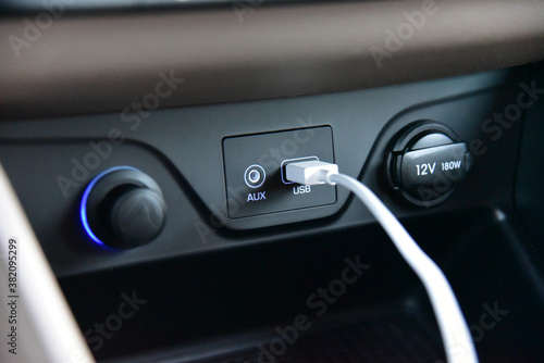 Connected USB cable into the USB port on the car dashboard photo