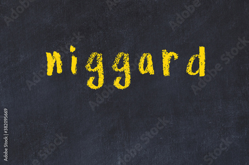 College chalk desk with the word niggard written on in photo