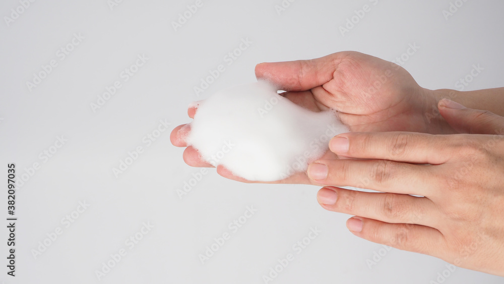 Hands washing gesture with foaming hand soap on white background.