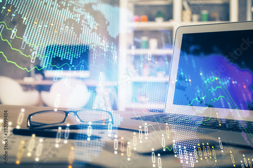 Financial graph colorful drawing and table with computer on background. Double exposure. Concept of international markets.