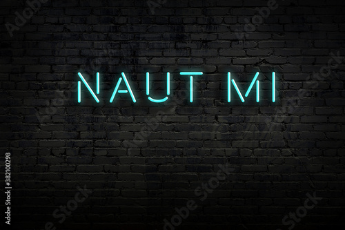 Night view of neon sign on brick wall with inscription naut mi photo