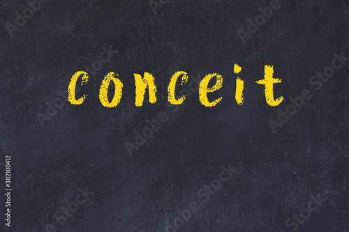 Fotografi Black chalkboard with inscription conceit on in
