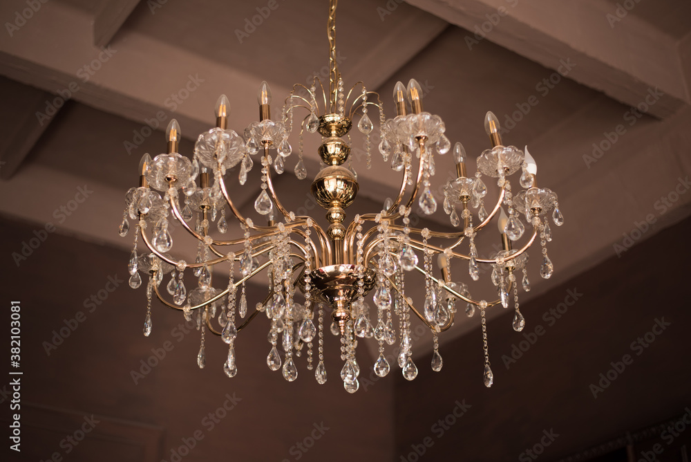Chrystal chandelier lamp on the ceiling in Dining room Adjusting the image in a Luxury tone .Decorative elegant vintage and Contemporary interior Concept