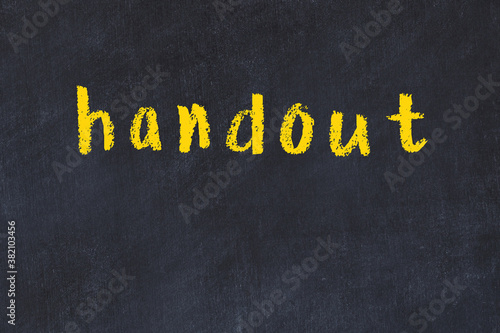 College chalk desk with the word handout written on in